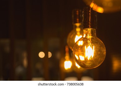 A glowing light bulbs. Light bulbs on a dark background with copy space.