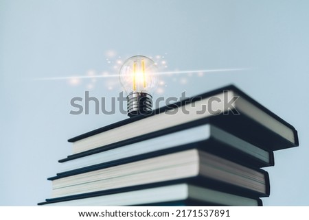 Glowing lightbulb or bright lamp with book or textbook. Skill improvement for student or businessperson. Studying and training course online at home. Business success idea, education learning concept
