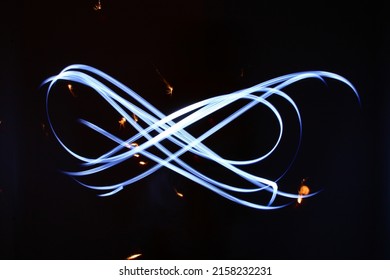 Glowing magic light effect and long trails fire motion. Abstract blue background with lines. draw light lines with lights LED with image blur.