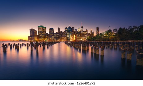 Glowing Manhattan skyline from Brooklyn. New York City with light relections on Hudon Bay