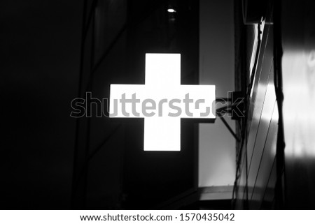 Glowing neon Cross hospital medical icon. First aid. Diagnostics symbol. Medicine and pharmacy sign.
