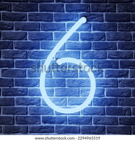 Glowing neon number 6 sign on brick wall