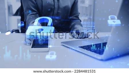 Glowing padlock icon with digital statistics and binary, businesswoman holding smartphone with laptop on desk. Concept of cybersecurity and internet privacy