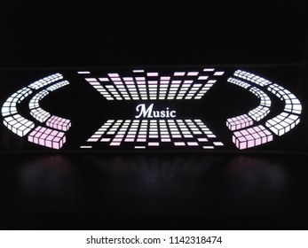 Glowing pixels and rectangles in the form of an equalizer of red, pink, yellow color with graphics and brightness