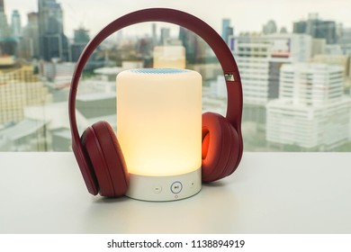 Glowing Portable Bluetooth Speaker In Bright Yellow Color With Cute Pink Wireless Headphones For Pairing To Listen To Music For Relaxation