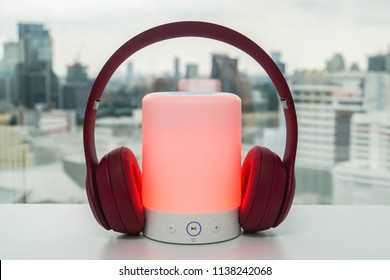 Glowing Portable Bluetooth Speaker In Red Color With Cute Pink Wireless Headphones For Pairing To Listen To Music