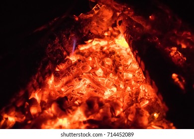 glowing to red coals in the forge