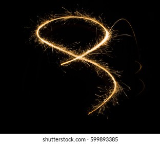 A Glowing Red Hot Sparkler Light Trail Isolated In Dark Environment Using Slow Shutter Speed.