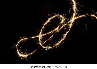 A glowing red hot sparkler light trail isolated in dark environment using slow shutter speed. - Powered by Shutterstock