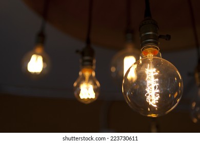 glowing round tungsten lamps on dark background