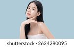 Glowing skin make up style of beautiful young Asian model isolated on blue background.