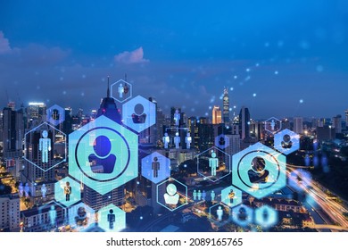 Glowing social media icons on night panoramic city view of Kuala Lumpur, Malaysia, Asia. The concept of networking and establishing new connections between people in businesses in KL. Double exposure.