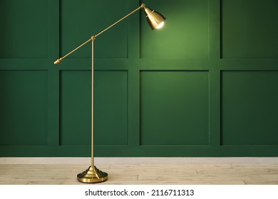 Glowing Standing Lamp Near Green Wall