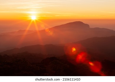 The glowing sun rising over mountains range on a cold winter day, the landscape of mountains on the morning mist. Inspiration, positive thinking concepts. Soft focus. - Powered by Shutterstock