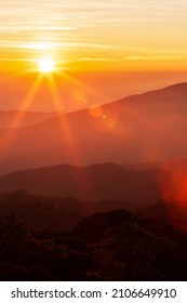 The glowing sun rising over mountains range on a cold winter day, the landscape of mountains on the morning mist. Inspiration, positive thinking concepts. Soft focus. - Shutterstock ID 2106649910
