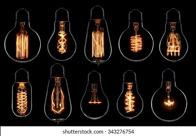 Glowing vintage light bulbs set. Black background