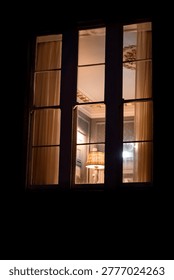 Glowing Windows with Curtains at Night, Warm and Safe Home Atmosphere	
