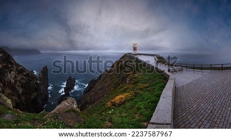 Similar – Leuchtturm an felsiger Küste am Meer