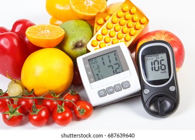 Glucose meter and blood pressure monitor with result of measurement, fruits with vegetables and medical pills, healthy lifestyle, diabetes, treatment and prevention of hypertension concept