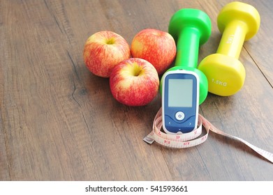  Glucose Meter,fruits And Dumbbells For Using In Fitness, Concept Of Diabetes, Exercise In Diabetes Patients Concept.