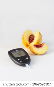 Glucose Monitor With The Rate And Peach On The White Bakground