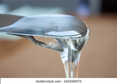 Glucose Syrop Confectionary Pouring From Spatula. Clear Thick Liquid. 