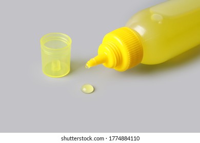 Glue Bottle Isolated On Gray Background