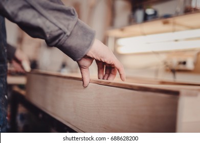 Glued curved piece of furniture with clamps. Carpenter screw clamp tools pressing wood slats and white glue - Powered by Shutterstock