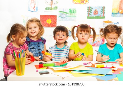 Gluing and painting lesson happy kids by the table - Shutterstock ID 181338788