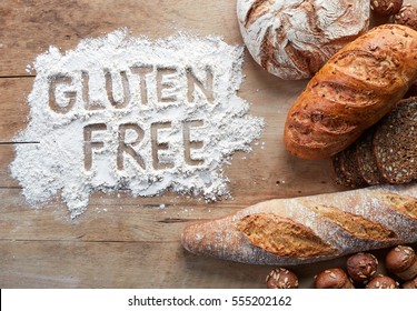 Gluten free bread on wooden background from top view - Shutterstock ID 555202162