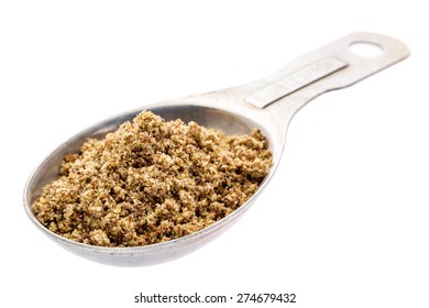 Gluten Free Brown Flax Meal On A Measuring Aluminum Tablespoon Isolated With Clipping Paths