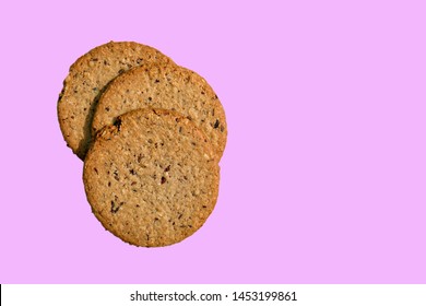 Gluten Free Oatcake made with flaxseeds and raisins - suitable for vegans. Isolated on a pink background.