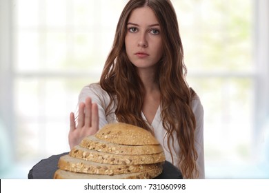 Gluten Intolerance And Diet Concept. Teenage Girl Refuses To Eat White Bread.