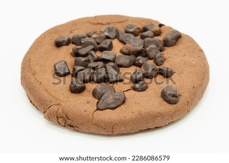 A gluten-free cocoa cookie with chocolate chips on a white background, close up cookie photo