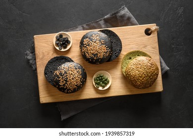 Gluten-free Trendy Vegan Burger Buns With Spirulina And Black Charcoal On Black Background. View From Above.