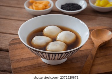 Glutinous rice balls filled with black sesame in sweet ginger soup
