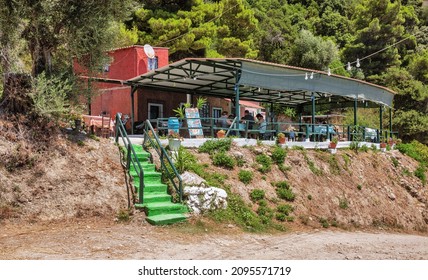 Glyfada, Corfu, Greece - August 06, 2021: People Visit Small Rural Greek Taverna Close To Mirtiotissa Beach. Corfu Is A Greek Island In The Ionian Sea.