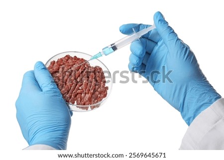 GMO concept. Scientist injecting something into minced meat on white background, closeup