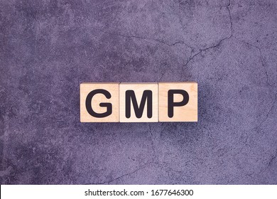 GMP Word Made With Wood Building Blocks.