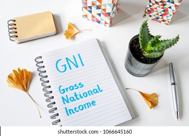 GNI Gross National Income Written In A Notebook On White Table