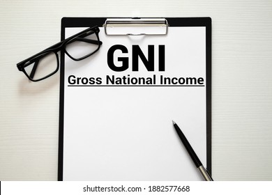 GNI Gross National Income Written In A Notebook On White Table.