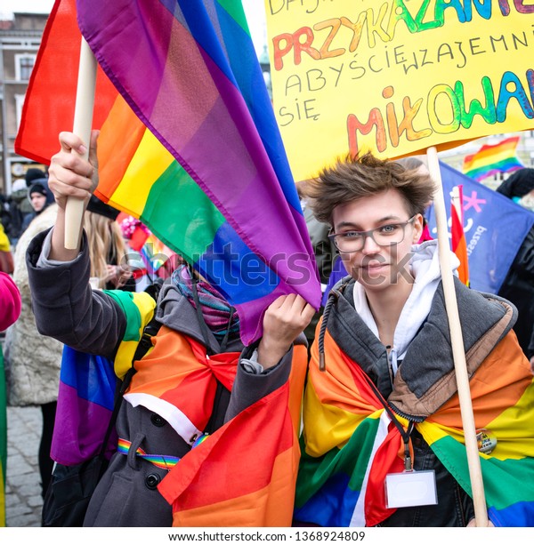 Gniezno / Poland - 04.13.2019: Gay parade or\
Equality March, crowd obserwing and people protesting and fighting\
with riot police\
forces.