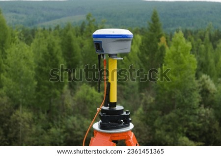 GNSS base station receiver running RTK mode at quiet and tranquil place among forest