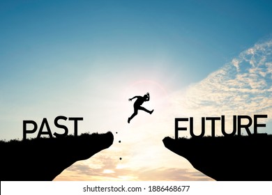 Go ahead and continuously improvement concept, silhouette man jump on a cliff from past to future with cloud sky background. - Shutterstock ID 1886468677
