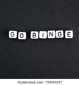 Go binge square composition phrase. Blace background white letters