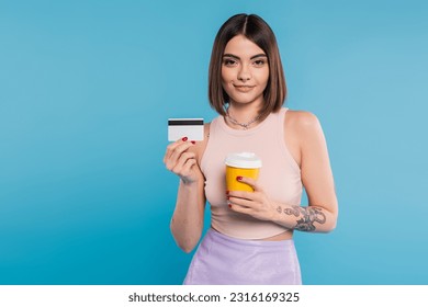 to go coffee, happy young woman with short hair, tattoos and nose piercing holding paper cup and credit card on blue background, generation z, summer trends, attractive, coffee culture - Powered by Shutterstock