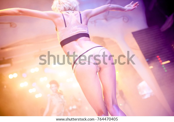 Go go dancer. Dance
show at night club with colorful lights show. Performance show
during night party.