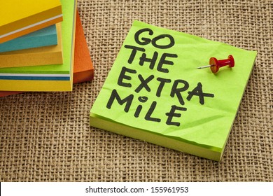 Go The Extra Mile  - Motivational Reminder Or Procrastination Concept  - Handwriting On Sticky Note - Handwriting On Sticky Note