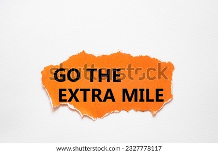 Go the extra mile symbol. Torn orange paper with words Go the extra mile. Beautiful white background. Business and Go the extra mile concept. Copy space.