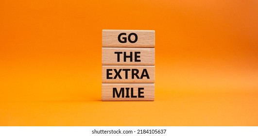 Go The Extra Mile Symbol. Wooden Blocks With Words Go The Extra Mile. Beautiful Orange Background. Business And Go The Extra Mile Concept. Copy Space.